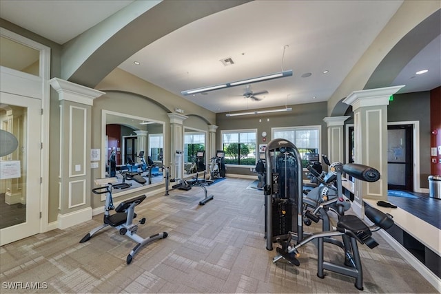 gym with ceiling fan, light carpet, and decorative columns