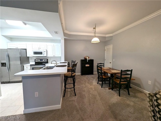 9005 Colby Dr Unit 1903, Fort Myers, FL 33919 - kitchen featuring a sink, a raised ceiling, a kitchen bar, appliances with stainless steel finishes, and visible vents