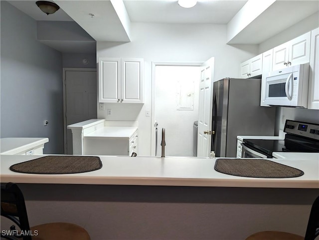 9005 Colby Dr Unit 1903, Fort Myers, FL 33919 - kitchen with white cabinetry, stainless steel appliances, and light countertops
