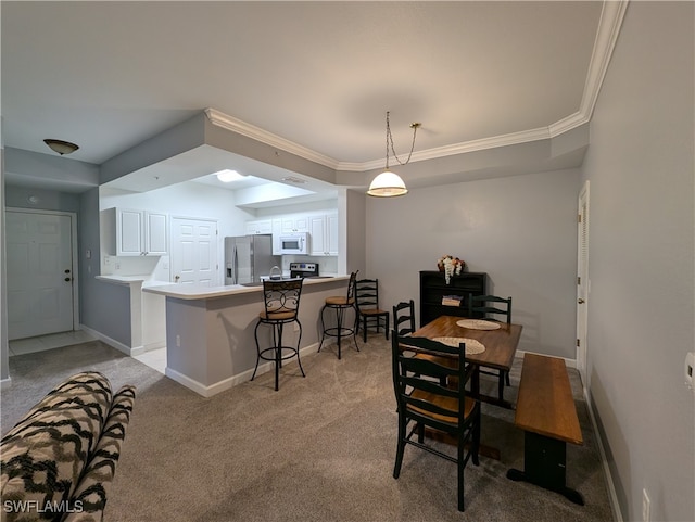 carpeted dining space featuring ornamental molding