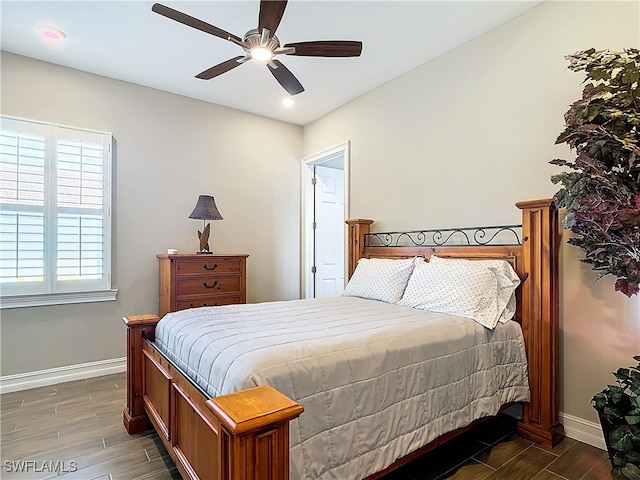 bedroom featuring dark hardwood / wood-style flooring and ceiling fan