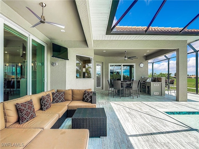 view of patio / terrace with glass enclosure, ceiling fan, and an outdoor hangout area