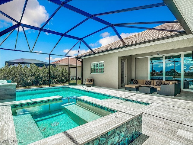 view of swimming pool with outdoor lounge area, an in ground hot tub, ceiling fan, and glass enclosure