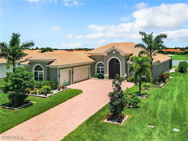 mediterranean / spanish house with a front yard and a garage