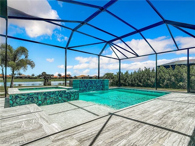 view of swimming pool featuring an in ground hot tub, a lanai, pool water feature, a water view, and a patio