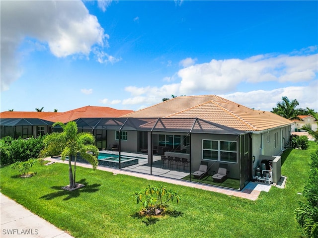 back of house with a lawn, a patio area, and a lanai