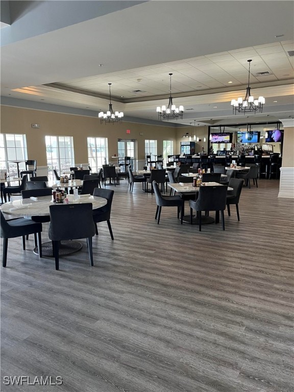 dining area featuring hardwood / wood-style floors and a raised ceiling