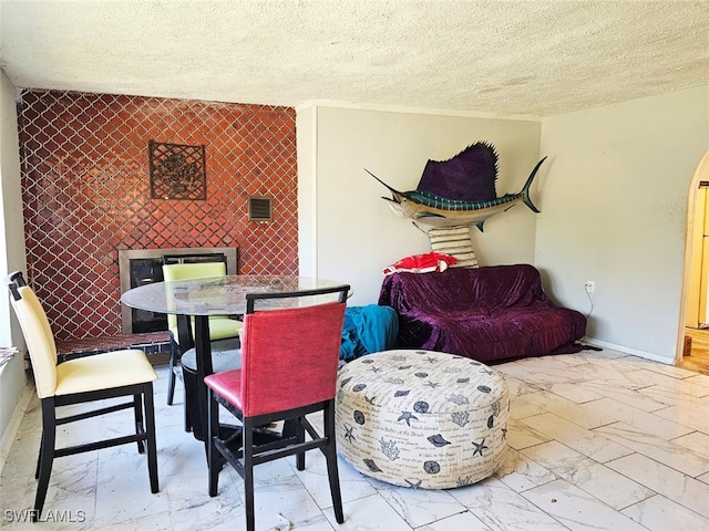 dining room with a textured ceiling and tile walls