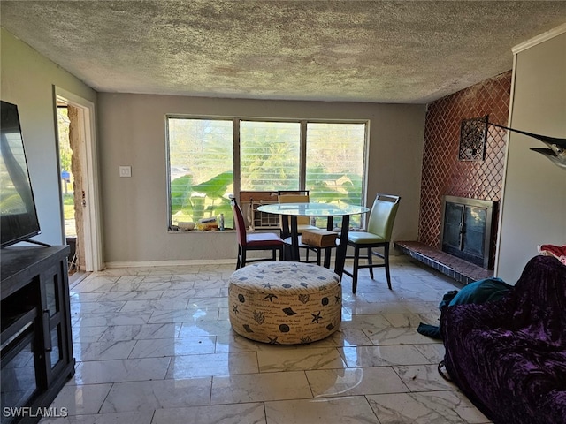 dining area featuring a textured ceiling and a fireplace