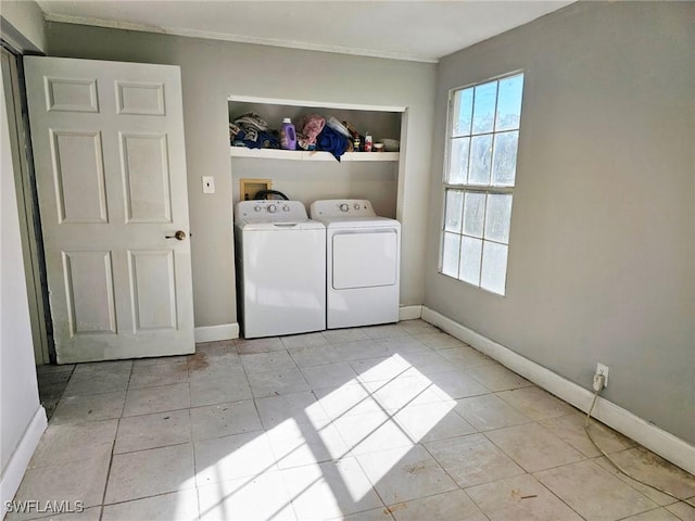 washroom with separate washer and dryer and light tile patterned floors