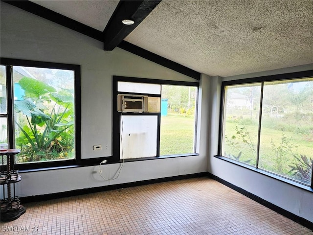 unfurnished sunroom with vaulted ceiling with beams