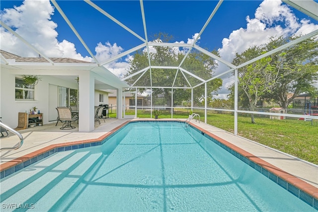 view of swimming pool with a lanai, a yard, and a patio area