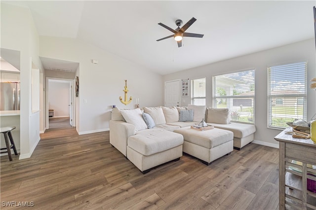 living room with ceiling fan, dark hardwood / wood-style flooring, and vaulted ceiling