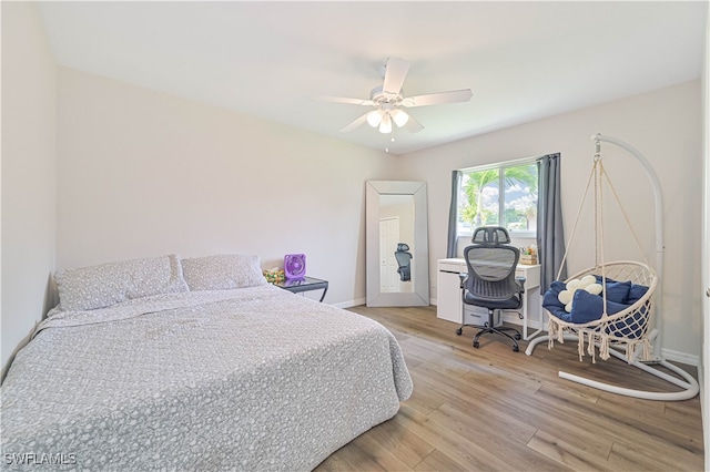 bedroom featuring light wood-type flooring and ceiling fan