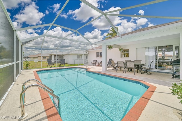 view of swimming pool with glass enclosure and a patio area