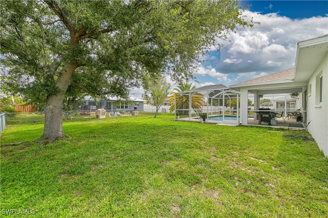 view of yard with a patio and glass enclosure