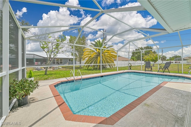 view of pool with a lawn, a patio, and glass enclosure