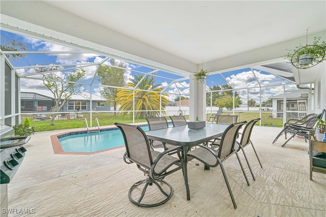 view of swimming pool featuring a lawn, a patio area, and glass enclosure