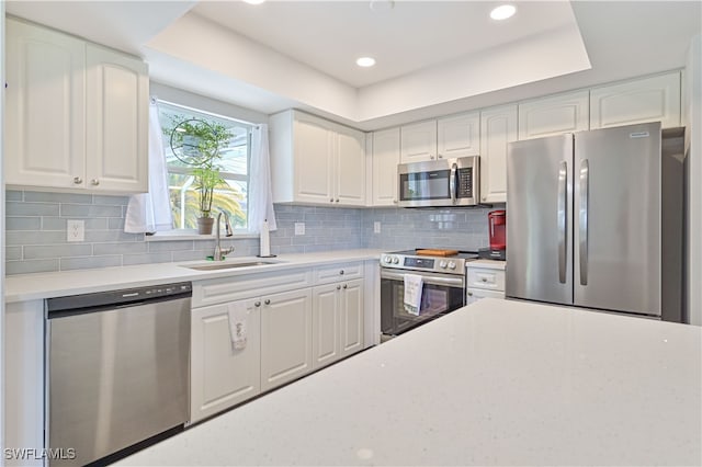 kitchen featuring white cabinets, appliances with stainless steel finishes, and sink