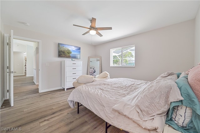 bedroom with ceiling fan and hardwood / wood-style flooring