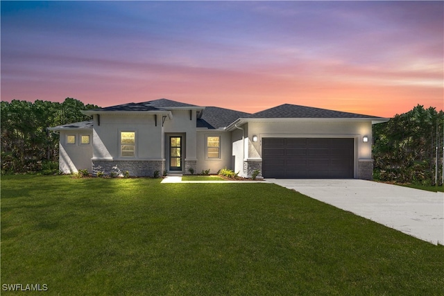 13 SW 34th Pl, Cape Coral, FL 33991 - prairie-style house with concrete driveway, stucco siding, an attached garage, stone siding, and a front lawn