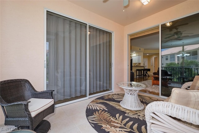 living room with ceiling fan and light tile patterned floors