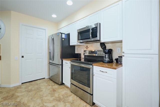 kitchen with appliances with stainless steel finishes, decorative backsplash, and white cabinetry