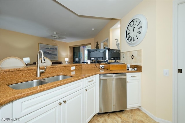 kitchen featuring stone counters, white cabinetry, dishwasher, sink, and ceiling fan