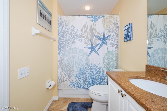 bathroom with tile patterned flooring, vanity, and toilet