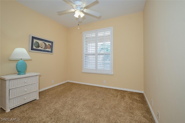 spare room with light colored carpet and ceiling fan