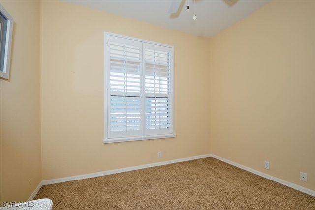 unfurnished room with plenty of natural light, ceiling fan, and carpet flooring