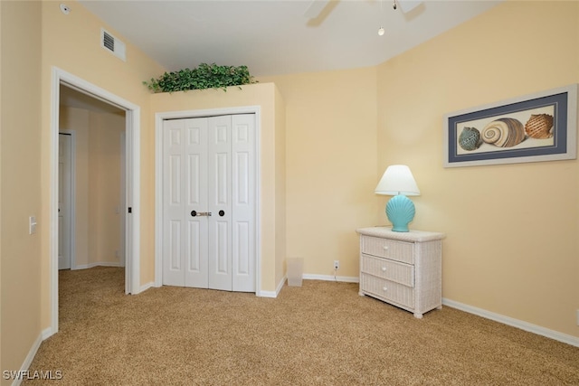 unfurnished bedroom with light colored carpet, ceiling fan, and a closet