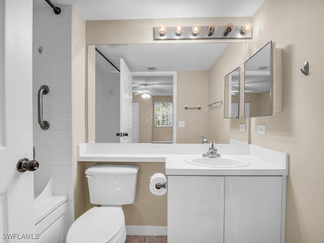 bathroom featuring tile patterned flooring, toilet, a tile shower, ceiling fan, and vanity