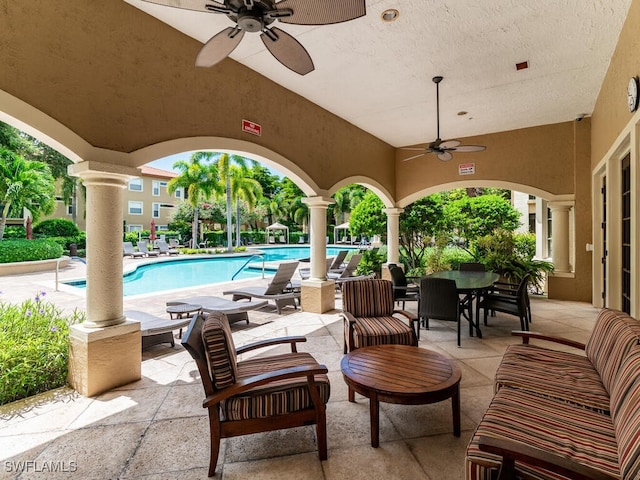 view of patio featuring an outdoor living space, ceiling fan, and a community pool