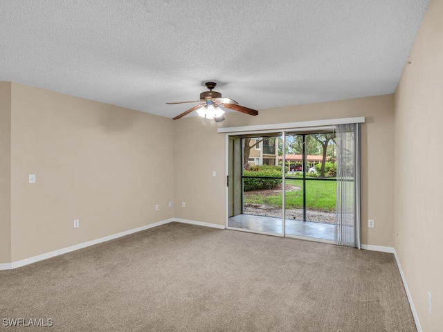 carpeted empty room featuring ceiling fan and a textured ceiling