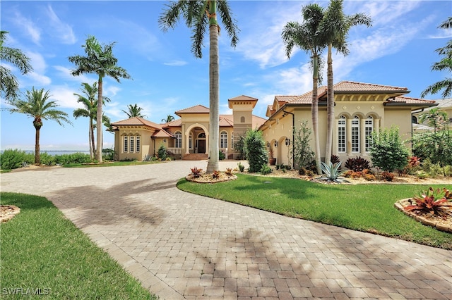 mediterranean / spanish home featuring a front yard