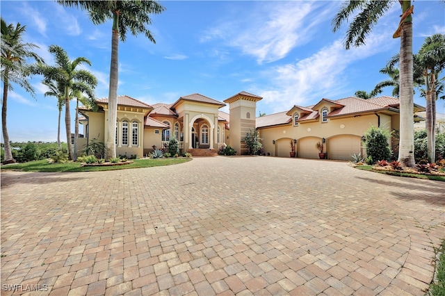 mediterranean / spanish home featuring a garage