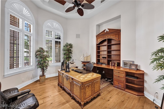 office space featuring light hardwood / wood-style flooring, ceiling fan, and a high ceiling