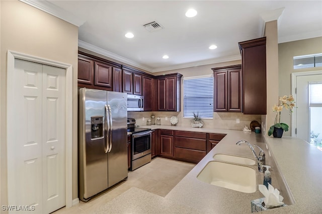 kitchen with visible vents, decorative backsplash, appliances with stainless steel finishes, light countertops, and a sink