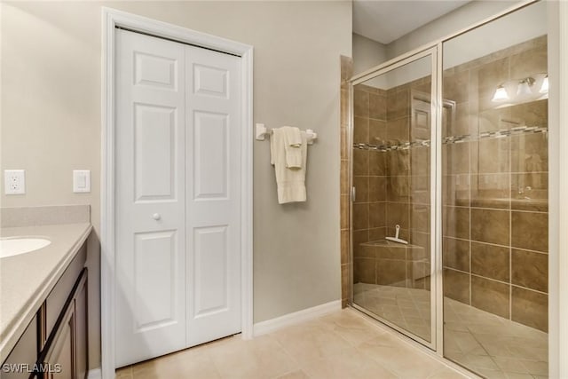 full bathroom featuring a stall shower, tile patterned flooring, and vanity