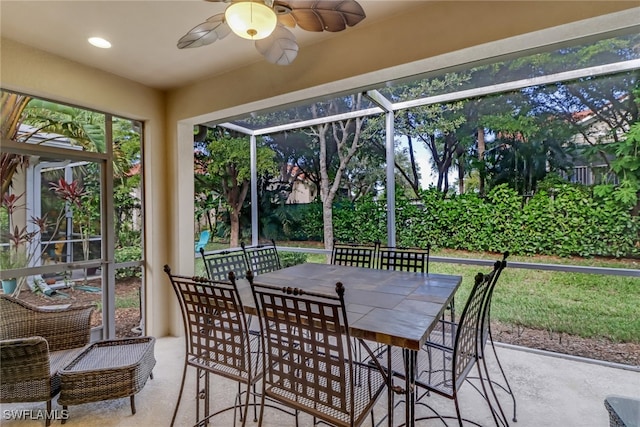 sunroom / solarium featuring a ceiling fan