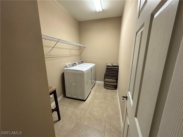 laundry area featuring laundry area, baseboards, and independent washer and dryer