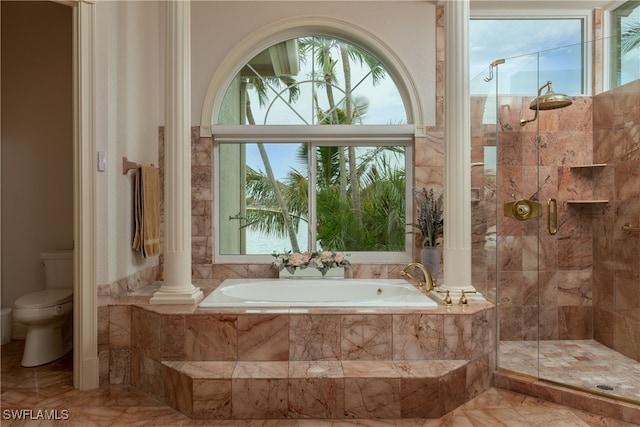 bathroom with a wealth of natural light, separate shower and tub, and toilet