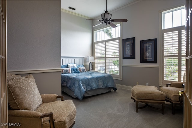 bedroom featuring ceiling fan, ornamental molding, and multiple windows