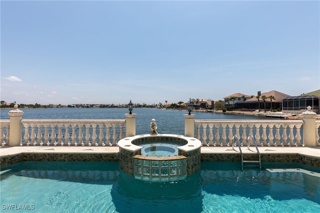 view of pool with a water view and an in ground hot tub