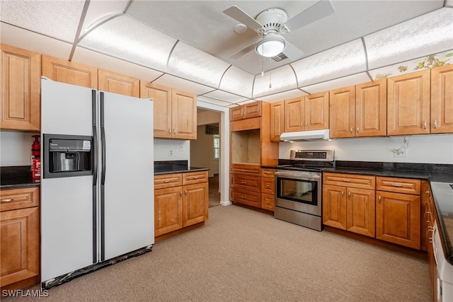 kitchen featuring white refrigerator with ice dispenser, light colored carpet, ceiling fan, and stainless steel electric range