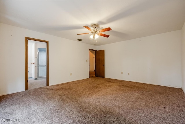 carpeted spare room with ceiling fan