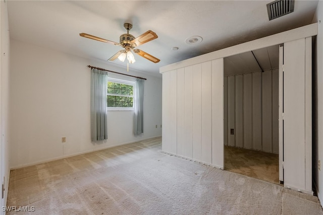 unfurnished bedroom featuring ceiling fan and light colored carpet