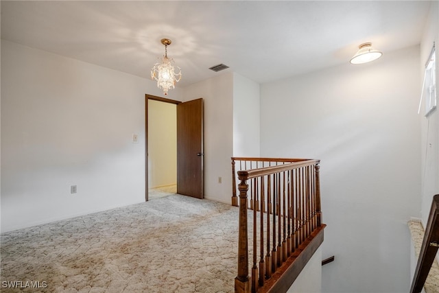 interior space featuring carpet flooring and an inviting chandelier