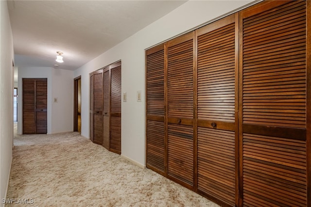 hallway with carpet floors